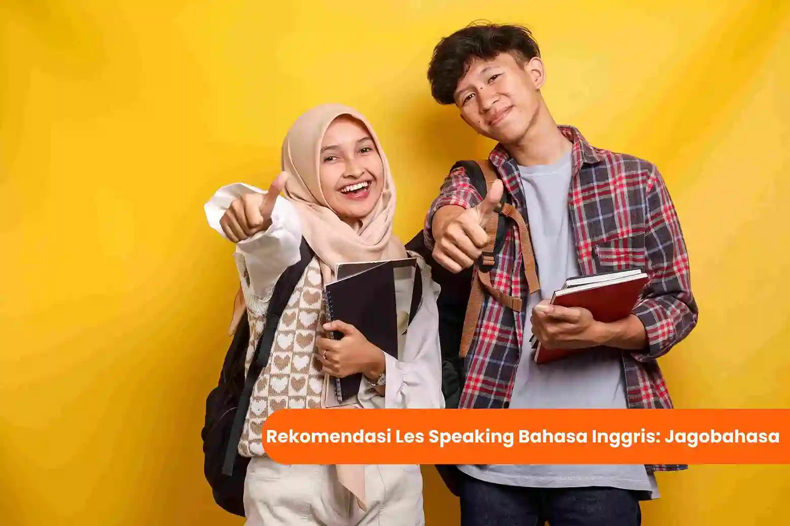 Thumbnail artikel Jagobahasa. Dua orang pria dan wanita yang sedang memegang buku sambil mengacungkan jempol. Di bawahnya terdapat tulisan rekomendasi les speaking bahasa inggris: Jagobahasa